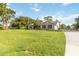 Well-maintained single-story home with a brick exterior, lush lawn, and an elongated driveway at 1330 Englewood Dr, St Cloud, FL 34772