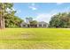 Well-maintained single-story home with brick facade, dark shutters, mature tree, and long driveway at 1330 Englewood Dr, St Cloud, FL 34772