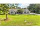 Well-maintained single-story home with a brick facade, dark shutters, mature tree, and lush green lawn at 1330 Englewood Dr, St Cloud, FL 34772