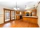 Spacious kitchen with wood cabinets, tile countertops and pendant lighting at 1330 Englewood Dr, St Cloud, FL 34772