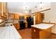 Spacious kitchen with wood cabinetry, tiled countertops, and modern appliances at 1330 Englewood Dr, St Cloud, FL 34772