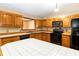 Bright kitchen featuring tile countertops and black appliances at 1330 Englewood Dr, St Cloud, FL 34772