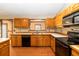 Well-lit kitchen featuring tile countertops and black appliances at 1330 Englewood Dr, St Cloud, FL 34772