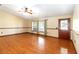 Bright living room featuring hardwood floors, natural light, and a stylish front door at 1330 Englewood Dr, St Cloud, FL 34772