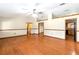 Spacious living room featuring hardwood floors, ceiling fan and views into kitchen at 1330 Englewood Dr, St Cloud, FL 34772
