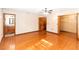 Open main bedroom features hardwood floors, a ceiling fan, and attached bathroom and closet at 1330 Englewood Dr, St Cloud, FL 34772