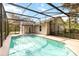 Sparkling screened-in pool with a clear blue water and a spacious deck in a backyard at 1330 Englewood Dr, St Cloud, FL 34772