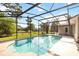 Screened-in pool with clear blue water and ample deck space, perfect for outdoor relaxation and entertainment at 1330 Englewood Dr, St Cloud, FL 34772