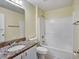 Bathroom featuring a vanity with granite countertop and a shower-tub combination at 310 Dagama Ct, Kissimmee, FL 34758