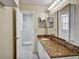Bathroom featuring granite countertops, vanity, mirror and a tiled shower at 310 Dagama Ct, Kissimmee, FL 34758