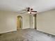 Bedroom featuring neutral carpeting, a ceiling fan, and an archway leading to other rooms at 310 Dagama Ct, Kissimmee, FL 34758