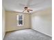 This bedroom features neutral walls, carpet, and natural light from a large window at 310 Dagama Ct, Kissimmee, FL 34758
