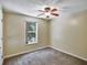 Bedroom featuring neutral walls, carpet, ceiling fan, and natural light from the window at 310 Dagama Ct, Kissimmee, FL 34758