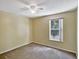 This bedroom features neutral walls, a ceiling fan and natural light from a large window at 310 Dagama Ct, Kissimmee, FL 34758