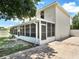 This home features a long screened in back porch and clean white siding at 310 Dagama Ct, Kissimmee, FL 34758