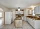 Spacious kitchen with tile flooring, white cabinets and an island at 310 Dagama Ct, Kissimmee, FL 34758