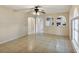 Bright living room showcasing tile floors and arched openings to the kitchen at 310 Dagama Ct, Kissimmee, FL 34758