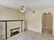 Living room with tile flooring, a decorative fireplace, and arched doorway at 310 Dagama Ct, Kissimmee, FL 34758