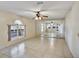 Open-concept living room with tiled floors, a mirrored wall and natural light at 310 Dagama Ct, Kissimmee, FL 34758