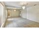 Spacious living room with tile flooring, large mirror wall and chandelier lighting at 310 Dagama Ct, Kissimmee, FL 34758