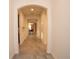 Inviting hallway with arched doorways and tile flooring leads into the home's living spaces at 4004 Prima Lago Cir, Lakeland, FL 33810