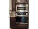 Modern kitchen appliances, including a built-in microwave and oven, complemented by stylish cabinets and countertops at 4004 Prima Lago Cir, Lakeland, FL 33810
