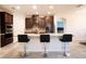 Modern kitchen with a large island, granite countertops, stainless steel appliances, and dark cabinets at 4004 Prima Lago Cir, Lakeland, FL 33810