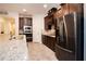 Beautiful kitchen features dark wood cabinetry, granite countertops, and stainless steel appliances at 4004 Prima Lago Cir, Lakeland, FL 33810