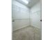 Walk-in closet with carpet flooring, multiple shelves and clothes bars, offering ample storage space at 4004 Prima Lago Cir, Lakeland, FL 33810