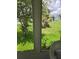 View from sunroom overlooking the lush, green backyard at 527 San Pedro Dr, The Villages, FL 32159