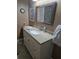 Bathroom featuring white vanity and a framed mirror at 527 San Pedro Dr, The Villages, FL 32159