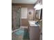 Well-lit bathroom featuring a walk-in shower, vanity with sink, and contemporary fixtures at 527 San Pedro Dr, The Villages, FL 32159