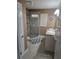 Bathroom featuring a glass shower, neutral paint, and a gray and white geometric rug at 527 San Pedro Dr, The Villages, FL 32159