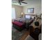 Cozy bedroom featuring a decorative black bedspread and a cherry colored storage bench at 527 San Pedro Dr, The Villages, FL 32159