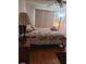 Bright bedroom with floral bedding, wood furniture, and natural light at 527 San Pedro Dr, The Villages, FL 32159