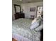 Well-lit bedroom with a comfortable bed, dresser, and ceiling fan at 527 San Pedro Dr, The Villages, FL 32159