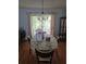 Open dining room with an oval table, chandelier and backyard access at 527 San Pedro Dr, The Villages, FL 32159