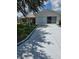 Lovely single-story home showcasing a manicured lawn, long driveway, and a screened-in garage at 527 San Pedro Dr, The Villages, FL 32159