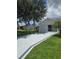 Charming single-story home with a manicured lawn, long driveway, and a screened-in garage at 527 San Pedro Dr, The Villages, FL 32159
