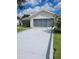 Charming single-story home with a spacious driveway and well-maintained landscaping at 527 San Pedro Dr, The Villages, FL 32159