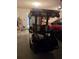 View of a golf cart parked inside a well-lit garage, offering a glimpse into the property's lifestyle amenities at 527 San Pedro Dr, The Villages, FL 32159