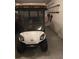 Inside the garage is a white golf cart, offering both convenience and leisure for active community living at 527 San Pedro Dr, The Villages, FL 32159