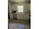 Kitchen featuring white cabinets, stainless steel appliances, and neutral countertops at 527 San Pedro Dr, The Villages, FL 32159