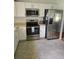 Well-lit kitchen featuring stainless steel appliances and white cabinetry at 527 San Pedro Dr, The Villages, FL 32159