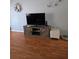 Living room featuring a large television on a wooden media console at 527 San Pedro Dr, The Villages, FL 32159