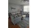 Cozy living room with modern gray couches, a coffee table, and a ceiling fan at 527 San Pedro Dr, The Villages, FL 32159