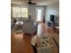 Open-concept living room with hardwood floors, neutral decor, and views of the front yard at 527 San Pedro Dr, The Villages, FL 32159