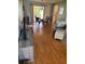Bright and airy living room featuring hardwood floors and a large sliding glass door to the outside at 527 San Pedro Dr, The Villages, FL 32159
