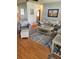 Cozy living room with neutral paint, wood floors, area rug, and comfortable seating at 527 San Pedro Dr, The Villages, FL 32159