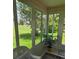 Bright sunroom with floor-to-ceiling windows offering tranquil views of the well-maintained lawn and mature trees at 527 San Pedro Dr, The Villages, FL 32159